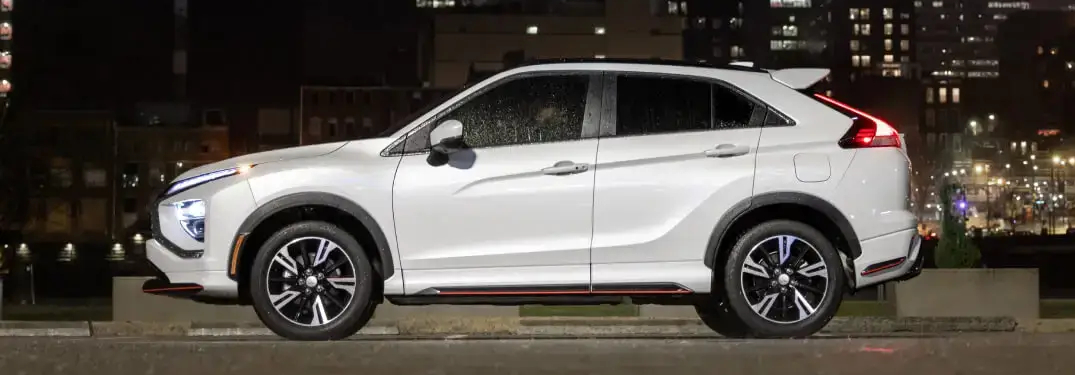 Profile of White 2024 Mitsubishi Eclipse Cross Parked in Front of City at Night