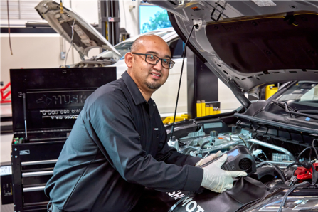 Mitsubishi Service Technician Looking Under Hood